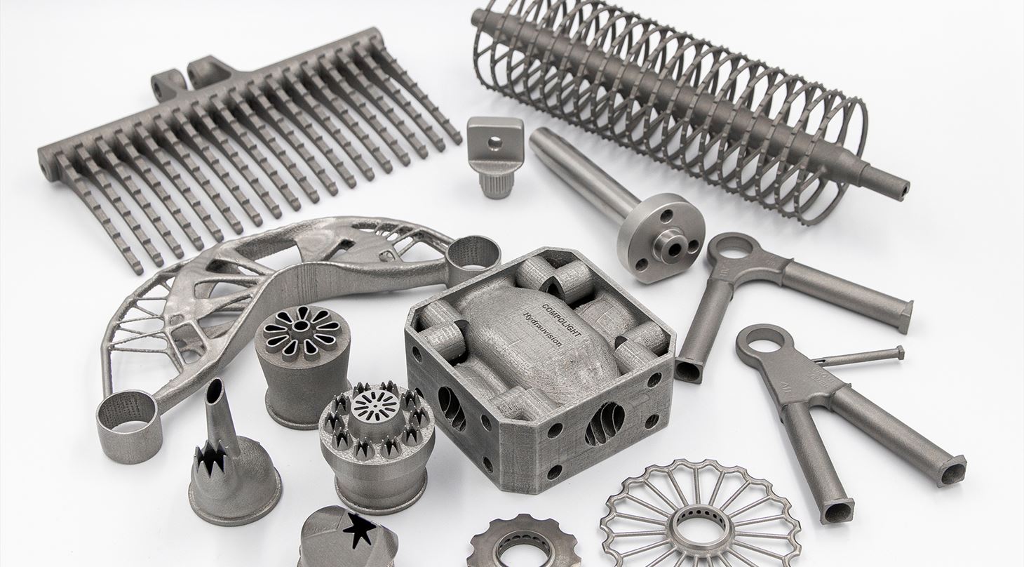 Mange 3D-printede metalemner på hvid baggrund